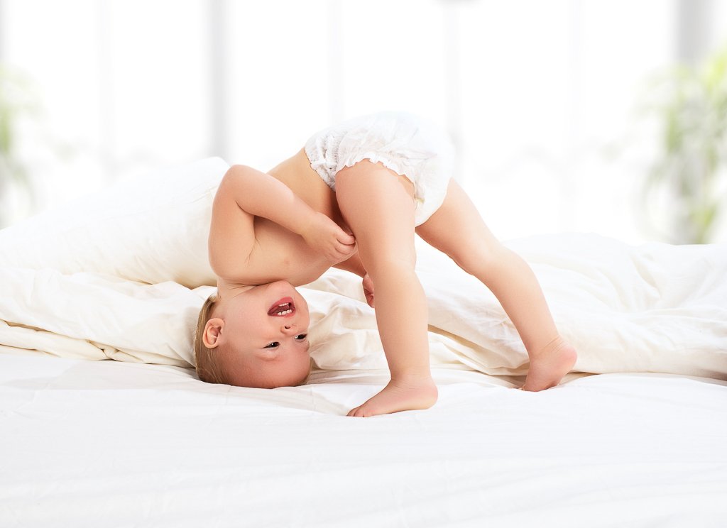 happy baby child play fun in bed